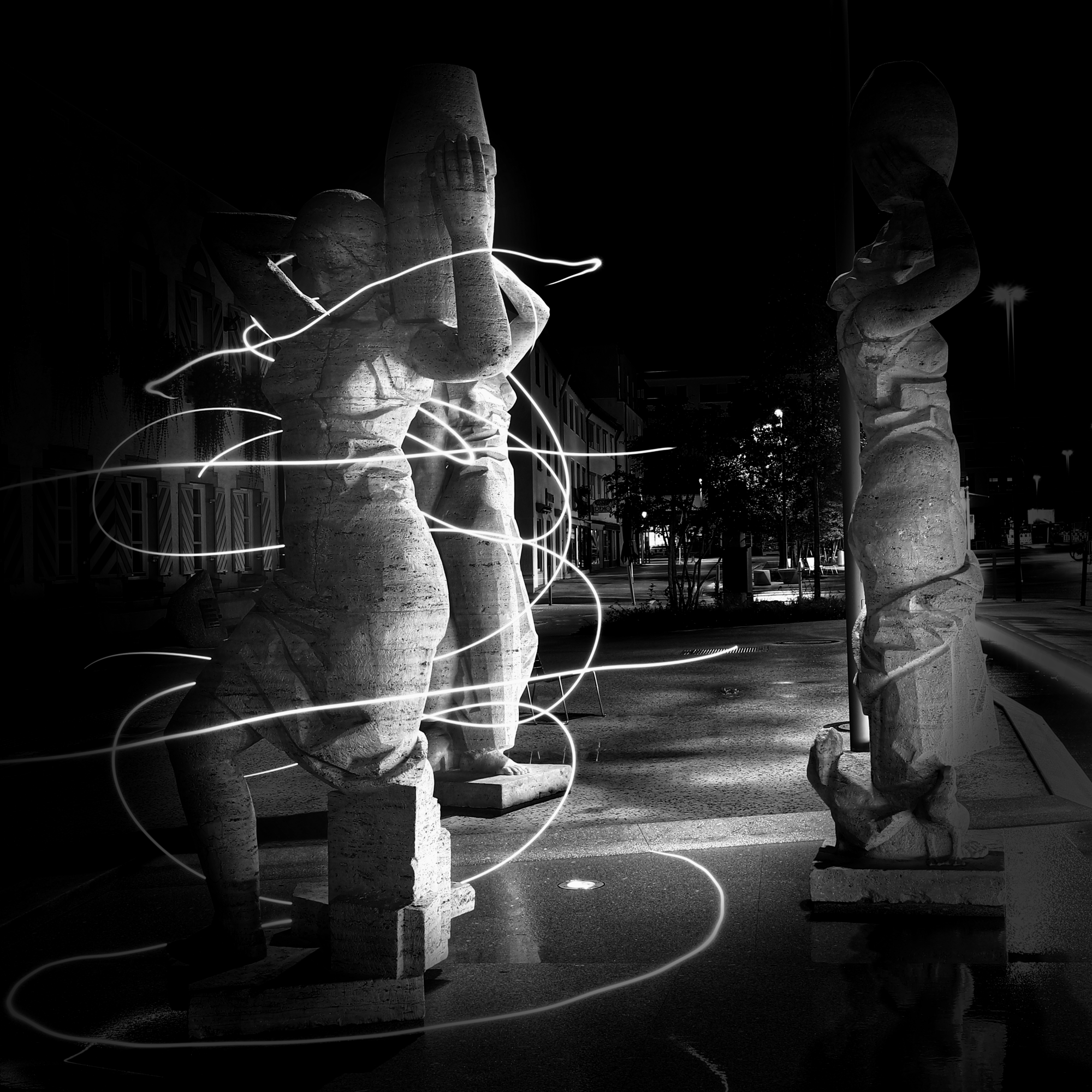 Die Wasserträgerinnen Statues of female watercarriers at night with swirls of light around them